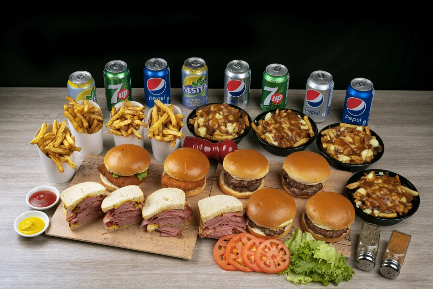 A Sam's Grill catering spread of burgers, smoked meat sandwiches, poutines, fries and drinks